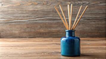 A blue ceramic diffuser bottle with wooden reeds aerial view photo