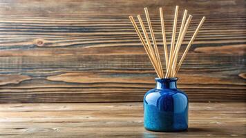 A blue ceramic diffuser bottle with wooden reeds photo