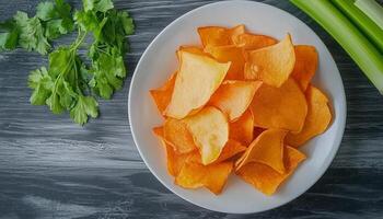 Pumpkin fried chips snack homemade in plate wooden background photo
