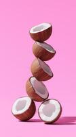 A stack of coconut fruit balancing vertical with isolated background photo