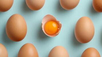 Egg pattern with a distinct anomaly of crushed shell showing egg yolk solid background photo