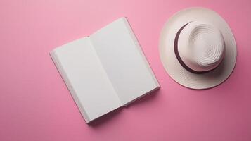 Blank white book open with white hat top of view copy space background photo