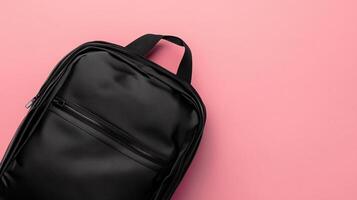 Black school bag a stationery place or working briefcase copy space pink background photo