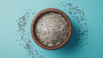 Chia seeds flour on brown wooden bowl and some seeds for baking, gluten free copy space photo