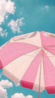 Umbrella pink and white beach for sunburn protection and blue sky bottom view photo