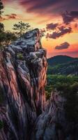 Edge rock cliff in mountain with sunset sky and cloud vertical story nature background photo