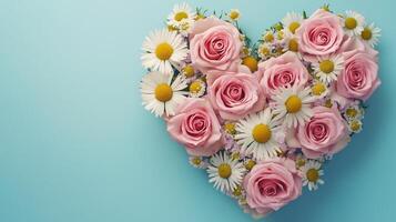 Chamomile and pink rose flowers are arranged in a heart-shaped arrangement flat lay view photo