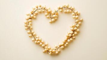 Meadowsweet arranged in the shape of a heart copy space blank white background photo
