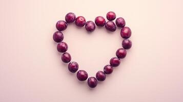 Plum fruit arranged in the shape of a heart copy space blank background photo
