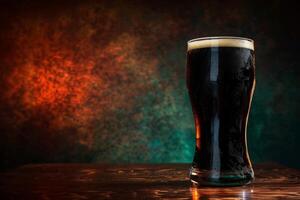 A glass of dark beer on a table photo