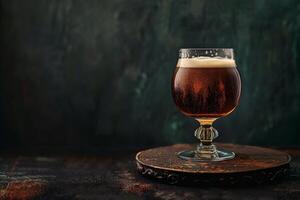 A glass of beer on a wooden table photo