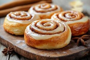 Cinnamon rolls on a wooden board with cinnamon and anise photo