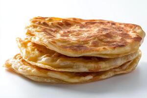 A stack of three flatbreads on a white surface photo