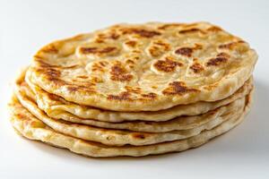 A stack of flatbreads on a white surface photo
