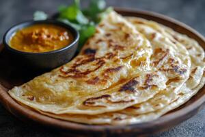 Indian flatbreads with curry sauce photo