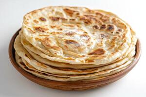 A bowl of flatbreads on a white surface photo