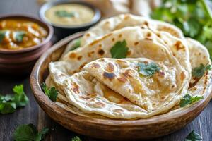 Indian flatbreads in a bowl with sauce photo