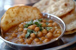 A bowl of chickpeas and bread on a plate photo