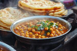 Indian food in a pot with bread and other food photo