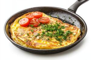 Omelet with tomato and parsley in a frying pan photo