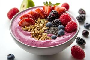 A bowl of fruit smoothie with berries, nuts and granola photo