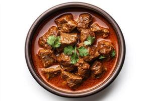Indian beef curry in a brown bowl on a white background photo