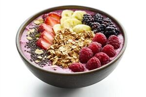 A bowl of fruit smoothie with granola and berries photo