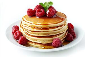 A stack of pancakes with raspberries and mint photo