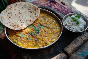 A bowl of corn and rice sitting on a table photo