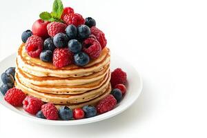 A stack of pancakes with berries on top photo