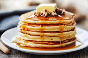 A stack of pancakes with syrup and butter photo