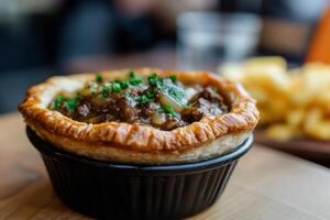 A small pie sitting in a black bowl photo
