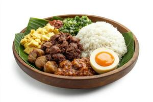 A bowl with rice, meat, eggs and a banana photo