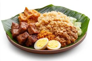 A plate with rice, meat and eggs on a leaf photo