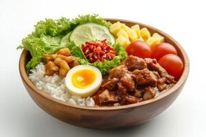 A bowl filled with rice, meat, eggs and vegetables photo