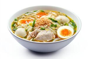 A bowl of soup with chicken, eggs and noodles photo