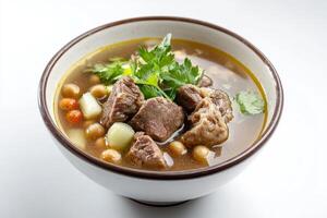 A bowl of soup with meat and vegetables photo