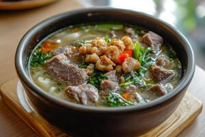A bowl of soup with meat and vegetables photo