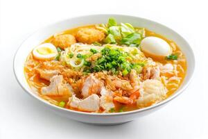 A bowl of ramen with meat, eggs and vegetables photo
