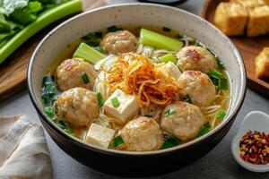 Chinese meatball soup with noodles and vegetables photo