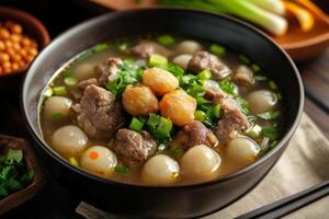 A bowl of soup with meat and vegetables photo
