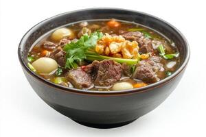 A bowl of beef and vegetables soup on a white background photo