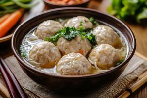 Chinese meatballs in soup with vegetables photo
