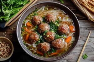 Chinese meatball soup with noodles and vegetables photo