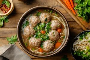 Chinese meatball soup with noodles and vegetables photo