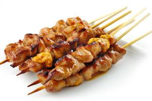 Chicken skewers with sauce on a white background photo