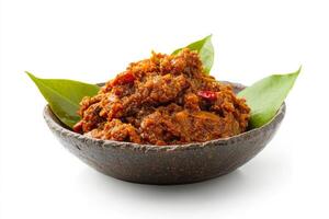 A bowl of curry with a leaf on top photo