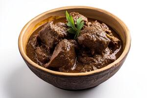 A bowl of beef stew with a sprig of herbs photo