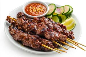 Thai beef satay on a plate with a side of sauce photo