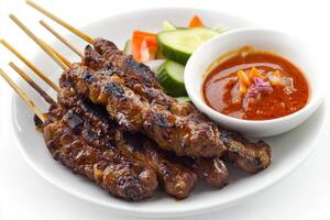 A plate with meat skewers and sauce photo